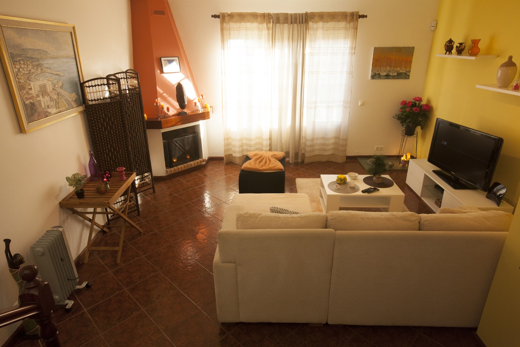 Living room with sofa seating, TV, and fireplace