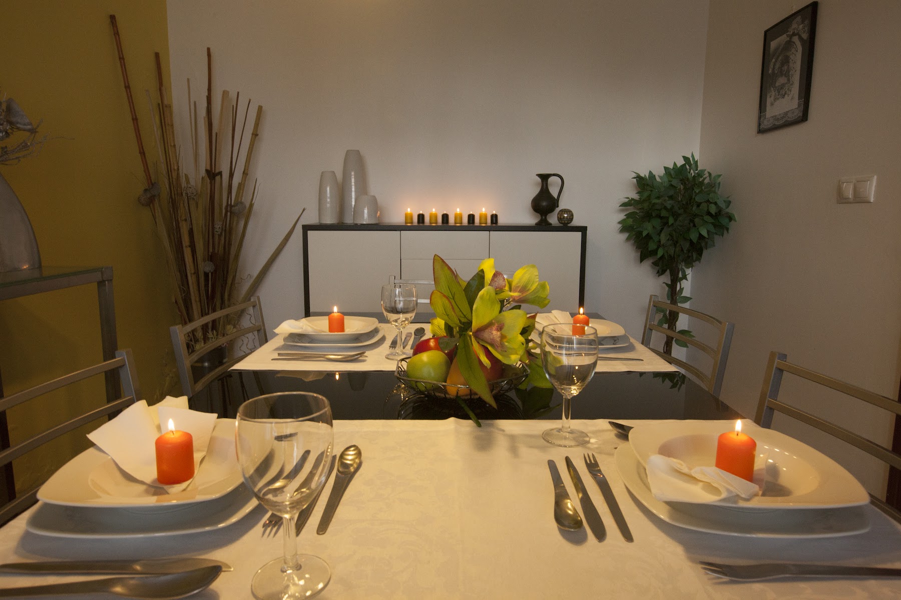 Dining table set with plates, glasses, and floral centerpiece